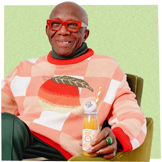 man sat drinking an innocent smoothie wearing a big knitwear jumper